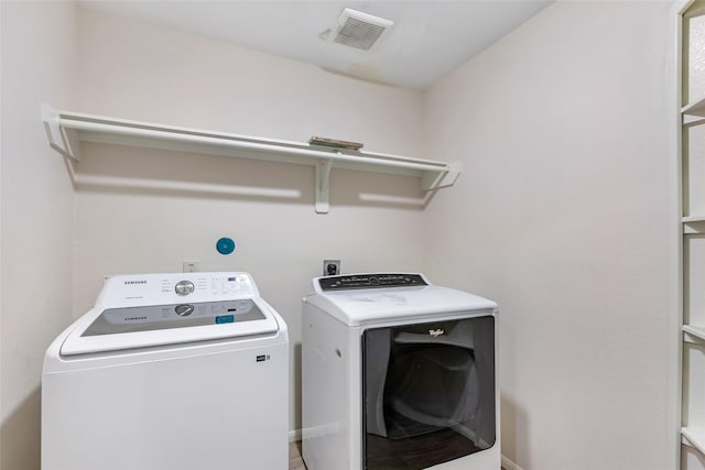 washroom with washer and dryer