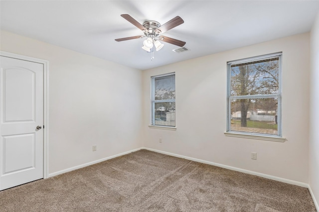 carpeted spare room with ceiling fan