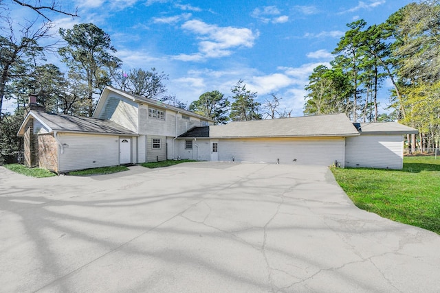 3130 Old Houston Rd, Huntsville, TX 77340 - view of front of house with brick siding, driveway, a front yard, and a chimney