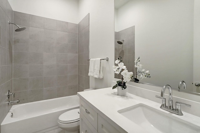 full bathroom with toilet, vanity, and tiled shower / bath