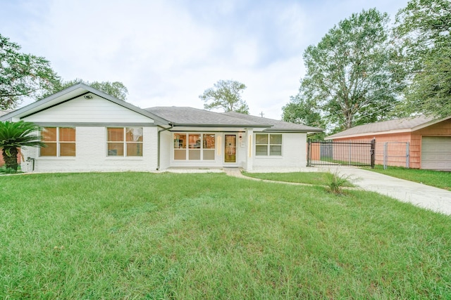 ranch-style home featuring a front yard and a garage