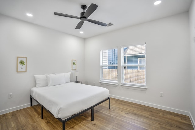 bedroom with hardwood / wood-style floors and ceiling fan