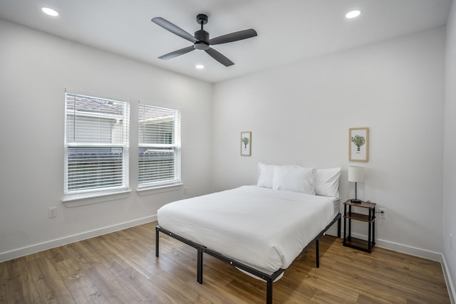 bedroom with hardwood / wood-style floors and ceiling fan