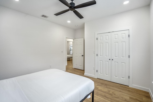 bedroom with ceiling fan, a closet, and light wood-type flooring