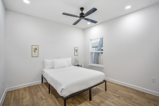 bedroom with ceiling fan and hardwood / wood-style floors