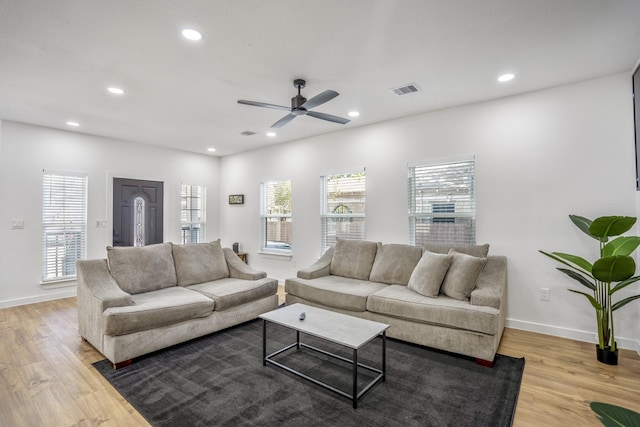 living room with light hardwood / wood-style flooring and ceiling fan