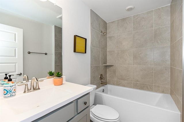 full bathroom with vanity, toilet, and tiled shower / bath