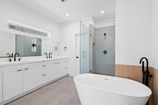 bathroom with plus walk in shower, wooden walls, vanity, and concrete floors