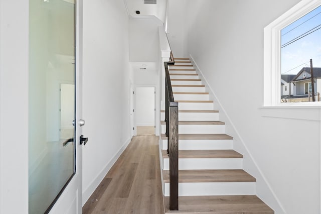 stairs featuring wood-type flooring