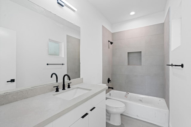 full bathroom with vanity, tile patterned flooring, tiled shower / bath, and toilet