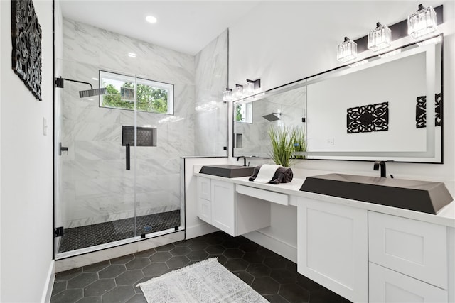 bathroom with double vanity, a sink, a marble finish shower, and recessed lighting