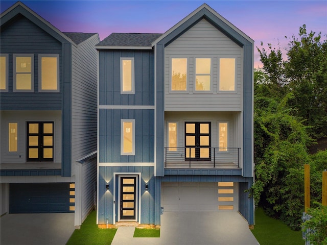 view of front facade featuring a balcony and a garage