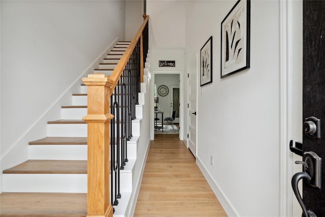 stairs featuring baseboards and wood finished floors