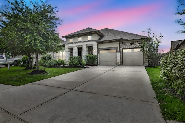 view of front of property featuring a lawn and a garage