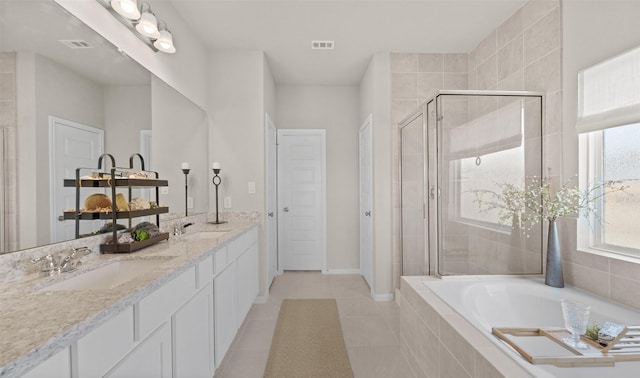 bathroom featuring tile patterned flooring, vanity, and shower with separate bathtub