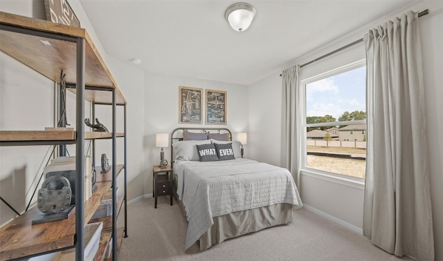 bedroom featuring light colored carpet