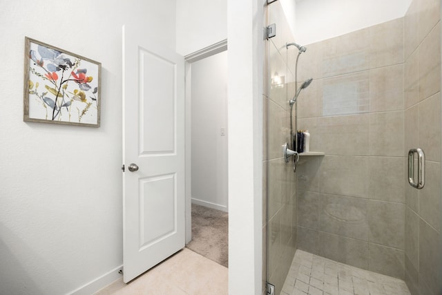 bathroom featuring tile patterned flooring and a shower with door