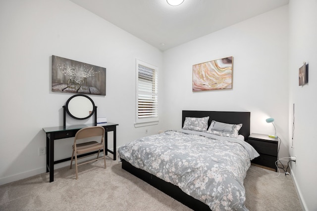 bedroom featuring light carpet