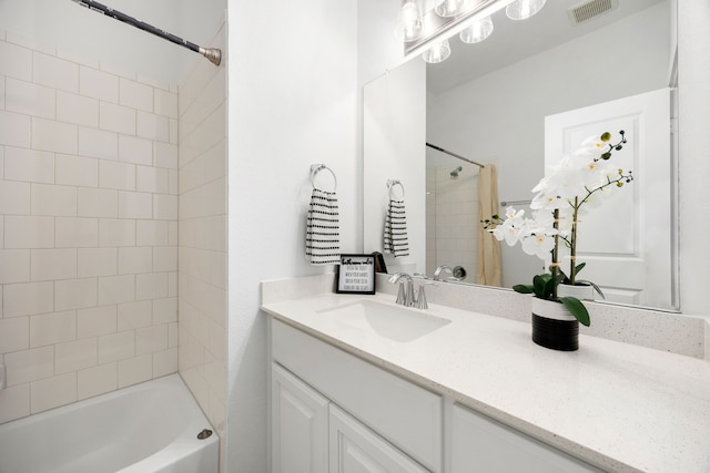 bathroom featuring vanity and tiled shower / bath combo