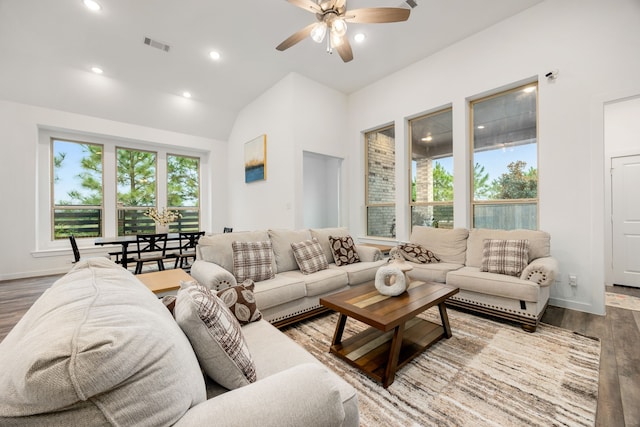 living room with wood-type flooring, ceiling fan, and lofted ceiling