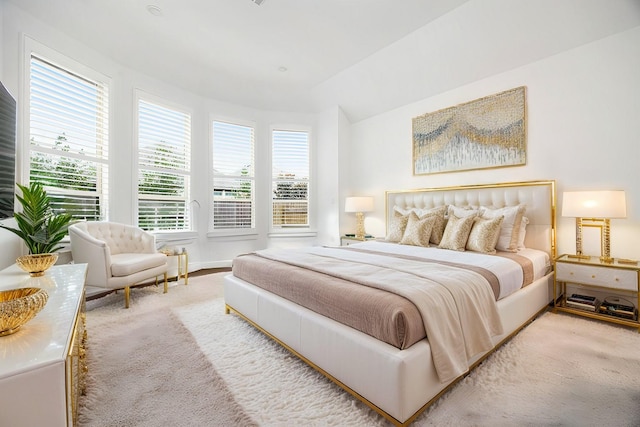 carpeted bedroom featuring vaulted ceiling