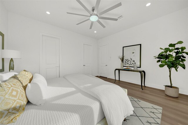 bedroom with hardwood / wood-style flooring and ceiling fan