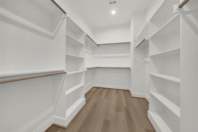 spacious closet with light hardwood / wood-style flooring