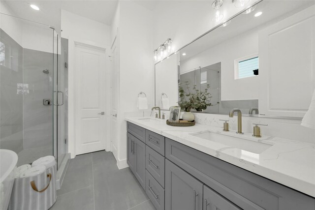 bathroom with vanity, tile patterned floors, and a shower with door