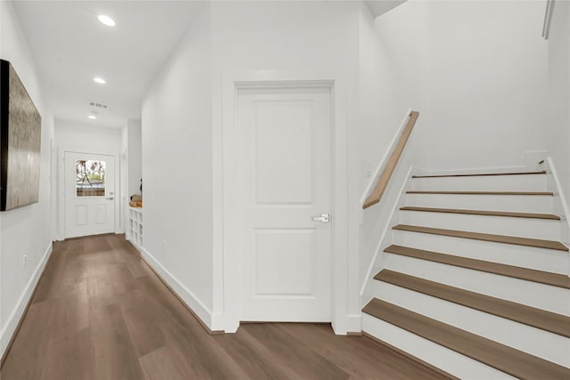 corridor with dark hardwood / wood-style floors