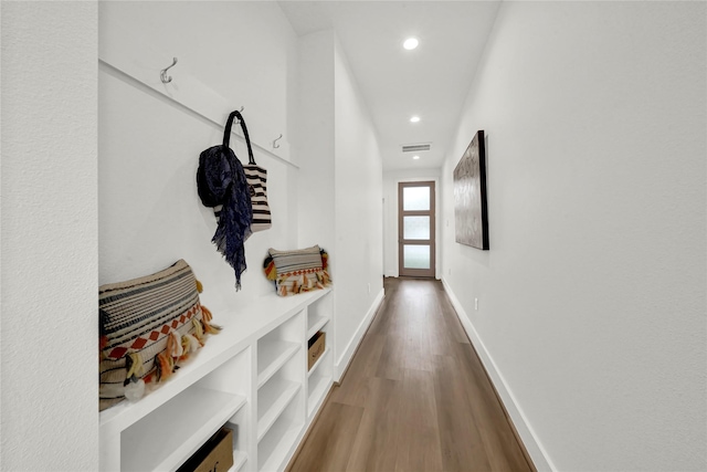 corridor with hardwood / wood-style flooring