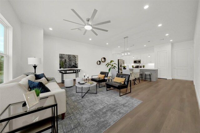 living room featuring ceiling fan and wood-type flooring