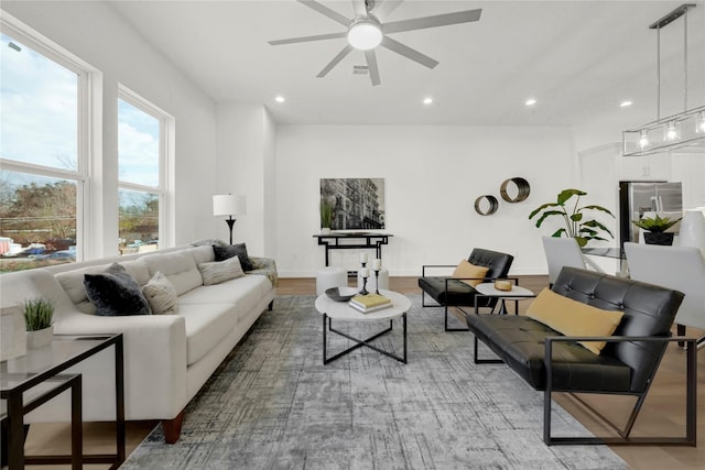 living room with hardwood / wood-style floors and ceiling fan