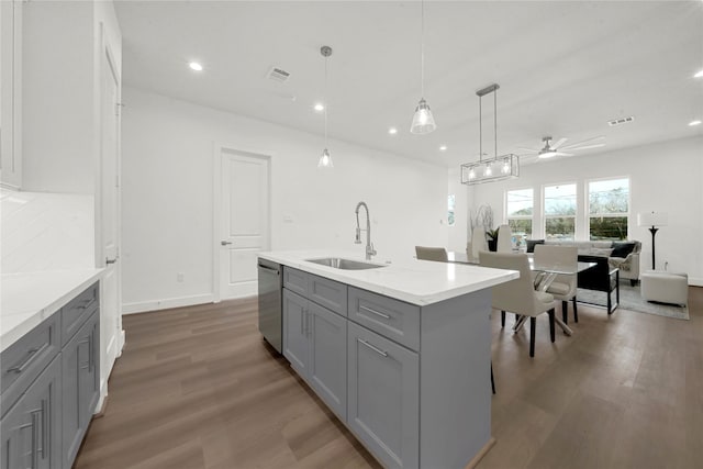 kitchen with ceiling fan, sink, stainless steel dishwasher, decorative light fixtures, and gray cabinets