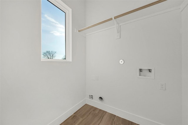 clothes washing area with hookup for a gas dryer, washer hookup, and wood-type flooring