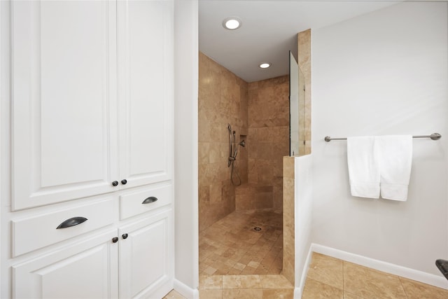 bathroom featuring tile patterned flooring and a tile shower