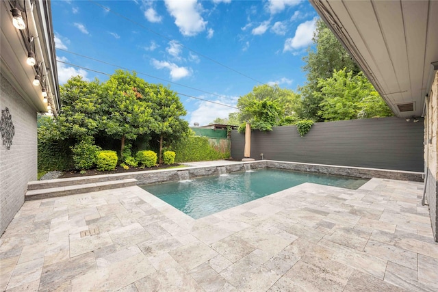 view of swimming pool featuring pool water feature and a patio area