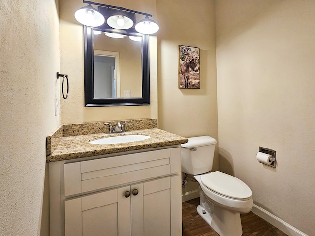 bathroom featuring hardwood / wood-style floors, vanity, and toilet