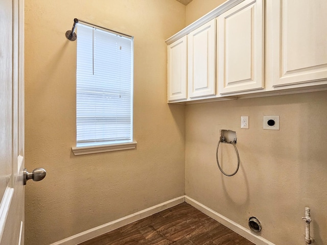 laundry room with hookup for an electric dryer, washer hookup, dark hardwood / wood-style floors, and cabinets