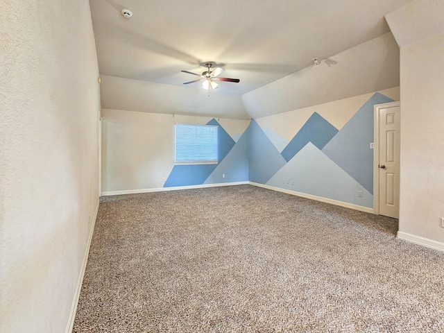 additional living space featuring carpet flooring, ceiling fan, and vaulted ceiling