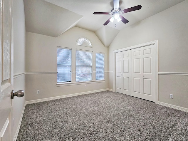 unfurnished bedroom with carpet flooring, ceiling fan, a closet, and lofted ceiling