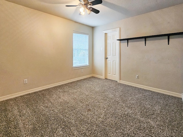 empty room with ceiling fan and carpet floors