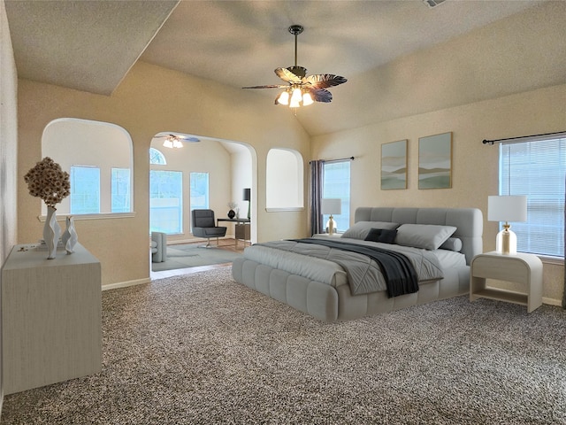 bedroom with multiple windows, ceiling fan, and carpet