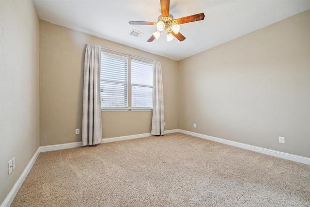 empty room with ceiling fan and light colored carpet