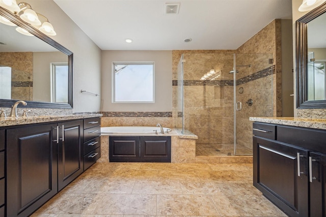 bathroom with vanity and separate shower and tub