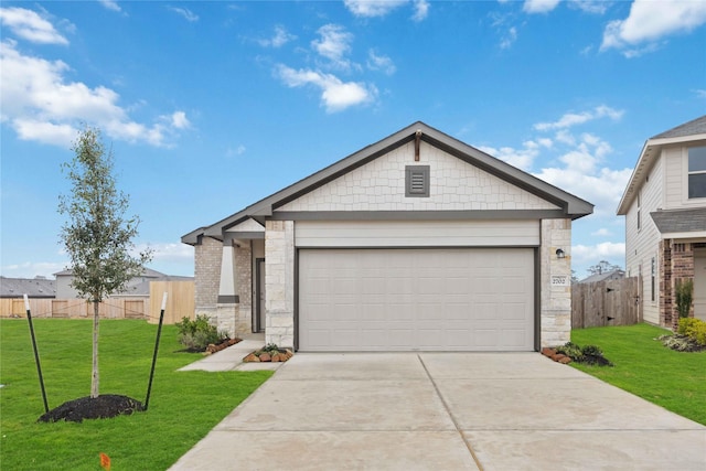 view of front of house with a front yard and a garage