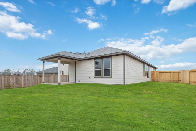 rear view of house with a patio area and a yard