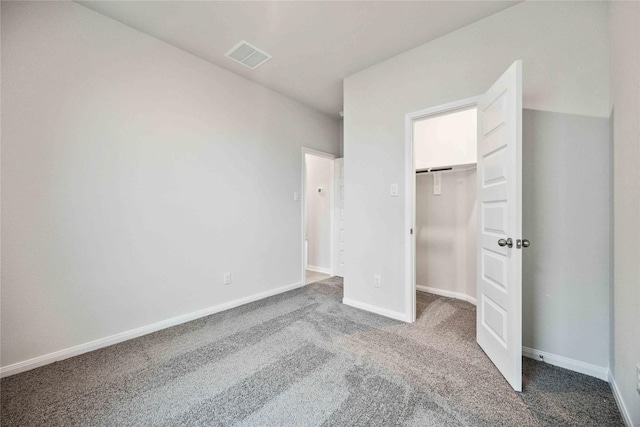 unfurnished bedroom featuring carpet floors and a closet