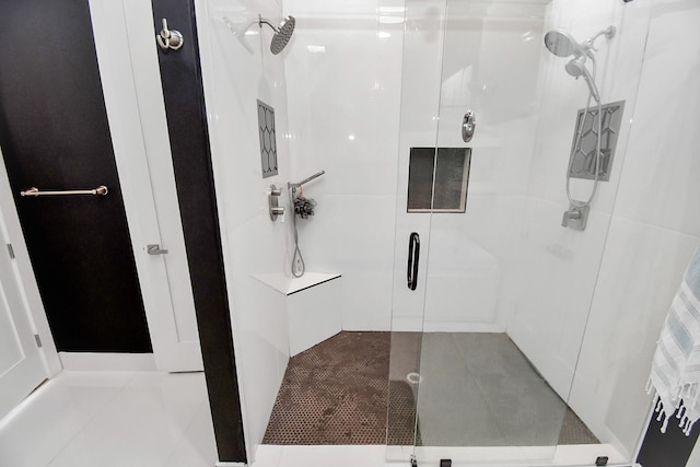 bathroom with tile patterned floors and a shower with door