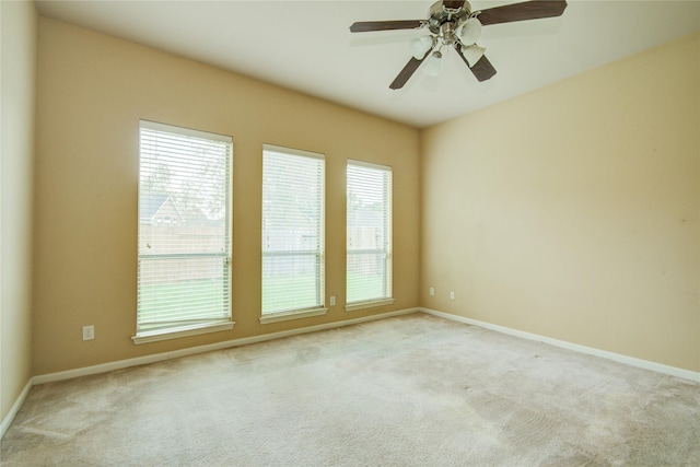 empty room featuring light colored carpet and ceiling fan