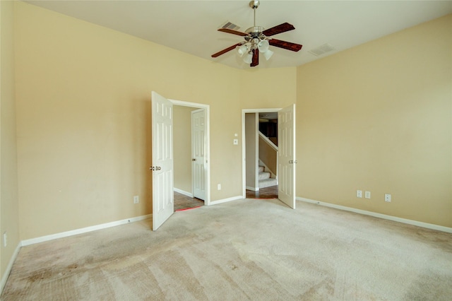 unfurnished bedroom featuring light colored carpet and ceiling fan